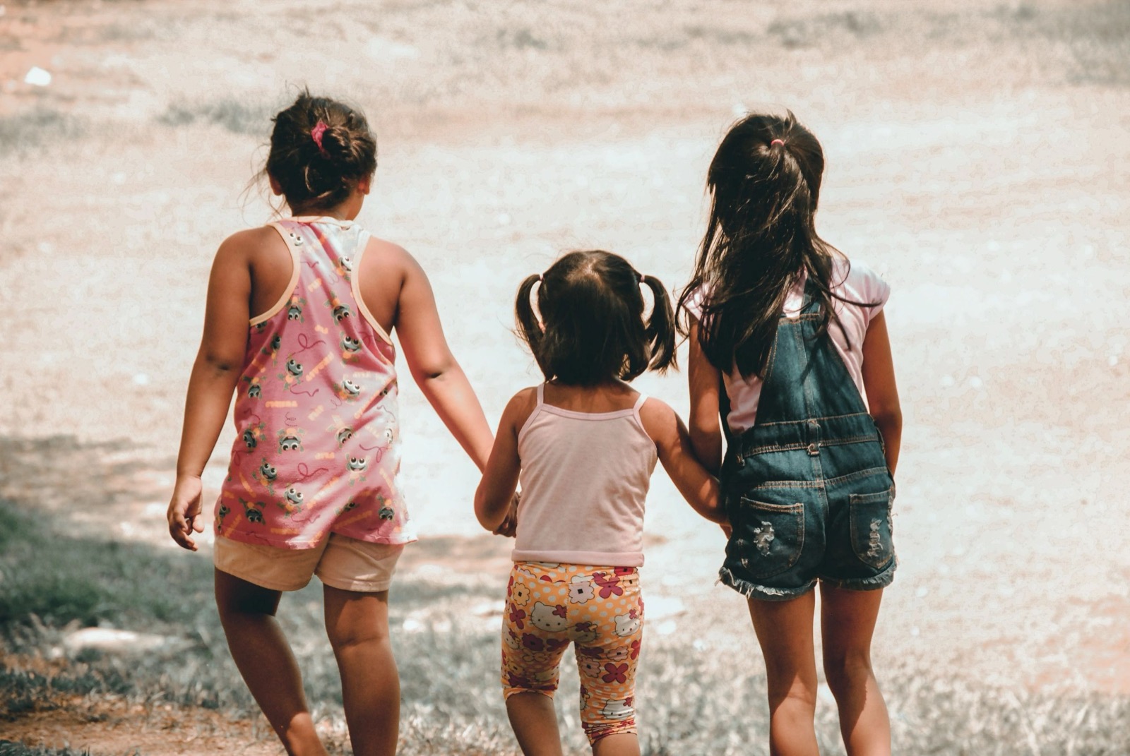 An adult and child walking together outdoors